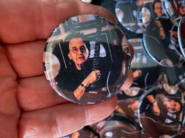John Regan memorial buttons made by Valerie Nadalini for fan giveaway at the 2023 NAMM show we attended